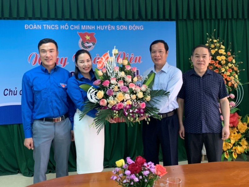 Đồng chí Nghiêm Xuân Hưởng, Bí thư Huyện ủy tặng hoa chúc mừng Huyện đoàn nhân ngày 26-3